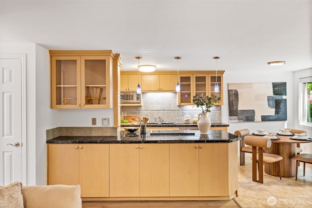 3834 175th Ave NE Unit 101, Redmond, WA 98052 - kitchen with stainless steel microwave, tile countertops, glass insert cabinets, and a peninsula