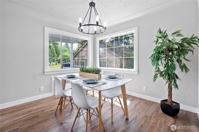 2319 Washington St SE, Olympia, WA 98501 - dining space featuring a chandelier, healthy amount of natural light, a textured ceiling, wood finished floors, and baseboards