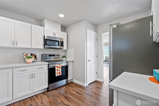 2319 Washington St SE, Olympia, WA 98501 - kitchen featuring stainless steel appliances, dark wood finished floors, baseboards, white cabinetry, and recessed lighting