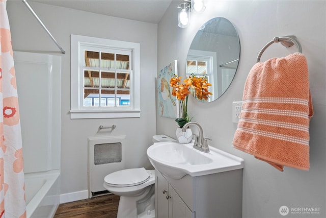 2319 Washington St SE, Olympia, WA 98501 - full bath with vanity, wood finished floors, toilet, shower / bath combo with shower curtain, and baseboards