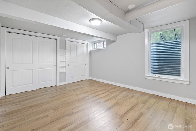 2319 Washington St SE, Olympia, WA 98501 - unfurnished bedroom featuring wood finished floors, baseboards, multiple closets, and beamed ceiling