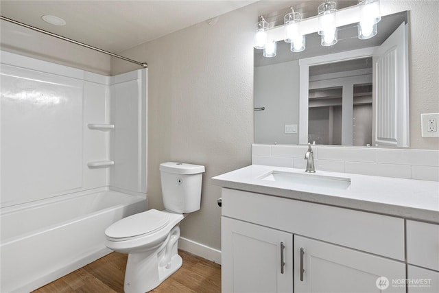 2319 Washington St SE, Olympia, WA 98501 - full bath with toilet, vanity, wood finished floors, shower / bath combination, and a textured wall