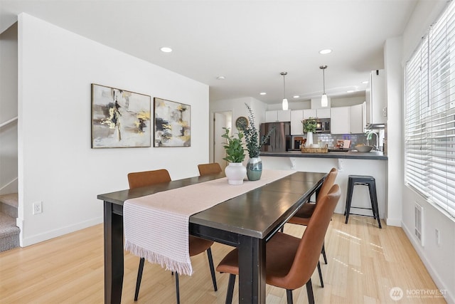 5028 Delridge Way SW Unit C, Seattle, WA 98106 - dining room with recessed lighting, light wood-style floors, and stairs