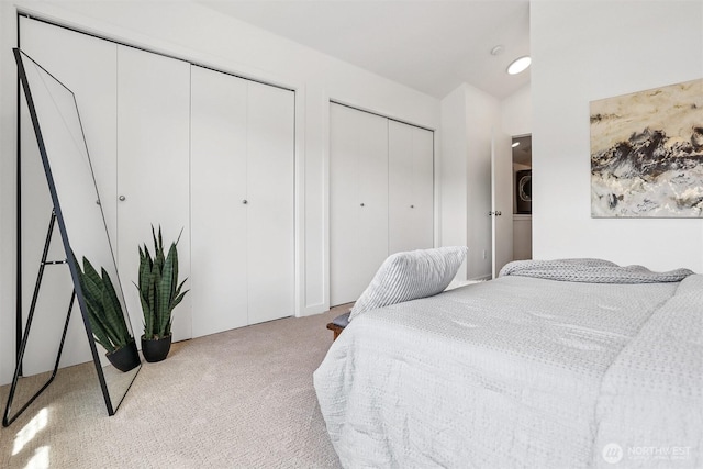5028 Delridge Way SW Unit C, Seattle, WA 98106 - bedroom with multiple closets, carpet, lofted ceiling, and stacked washer and clothes dryer