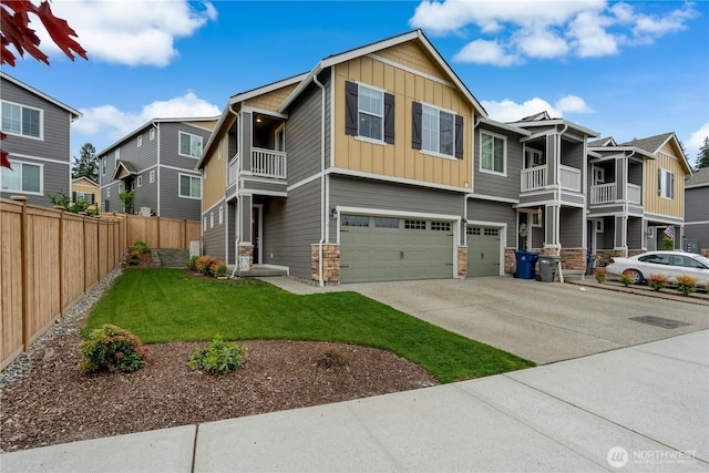 8323 E Gilman Ave, Arlington, WA 98223 - view of front of home featuring board and batten siding, a balcony, stone siding, a garage, and driveway