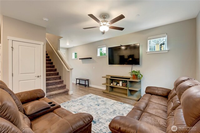 8323 E Gilman Ave, Arlington, WA 98223 - living room with a ceiling fan, stairway, baseboards, and light wood-style floors