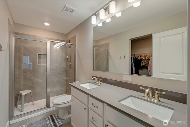 8323 E Gilman Ave, Arlington, WA 98223 - bathroom featuring a shower stall, toilet, double vanity, and a walk in closet