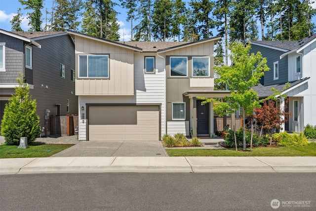 4502 Hibiscus Cir SW, Port Orchard, WA 98367 - view of front of house featuring board and batten siding, concrete driveway, an attached garage, and a shingled roof