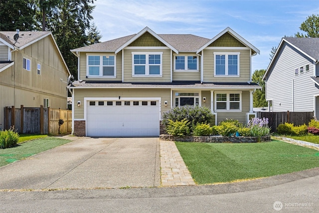 18216 80th Ave E, Puyallup, WA 98375 - view of front facade with concrete driveway, an attached garage, stone siding, and roof with shingles