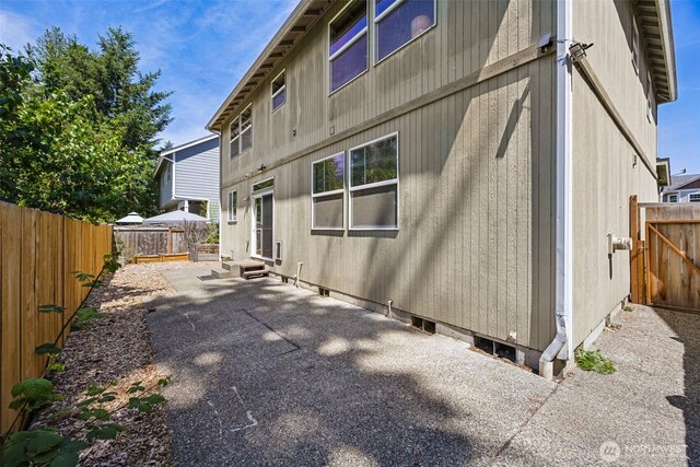 18216 80th Ave E, Puyallup, WA 98375 - rear view of house with a patio area, a fenced backyard, and entry steps