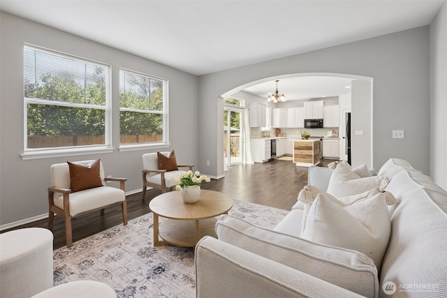 18216 80th Ave E, Puyallup, WA 98375 - living room with arched walkways, healthy amount of natural light, and wood finished floors