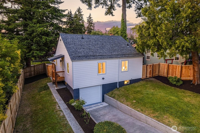 4022 N 19th St, Tacoma, WA 98406 - property exterior at dusk with a garage, roof with shingles, and concrete driveway