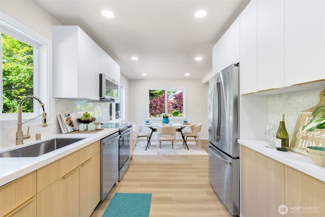 4022 N 19th St, Tacoma, WA 98406 - kitchen featuring appliances with stainless steel finishes, a sink, recessed lighting, light countertops, and light wood-style floors