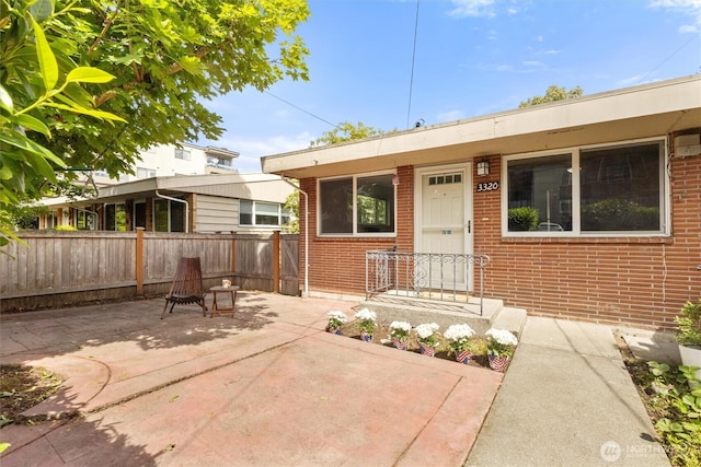 3320 NE 123rd St, Seattle, WA 98125 - view of front facade featuring brick siding and a patio