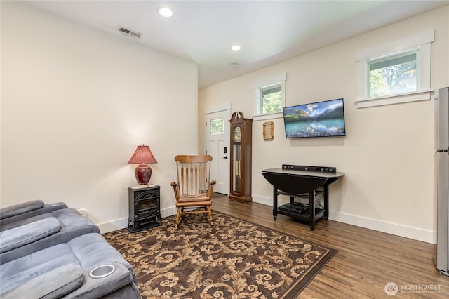 6214 207th Ave E, Bonney Lake, WA 98391 - living room featuring a wood stove, baseboards, wood finished floors, and recessed lighting