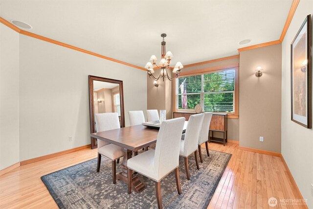 8795 Wood Duck Way, Blaine, WA 98230 - dining space with crown molding, a chandelier, and light wood finished floors