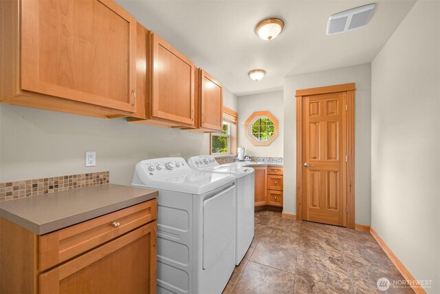 8795 Wood Duck Way, Blaine, WA 98230 - washroom with cabinet space, washer and dryer, and light stone finish floors