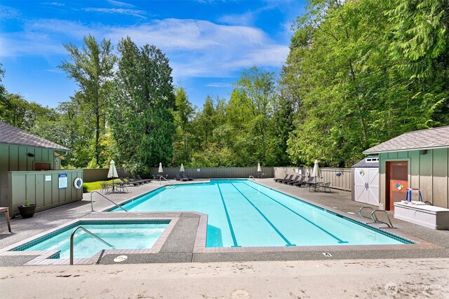 8795 Wood Duck Way, Blaine, WA 98230 - community pool with a hot tub, a patio area, view of wooded area, and an outdoor structure
