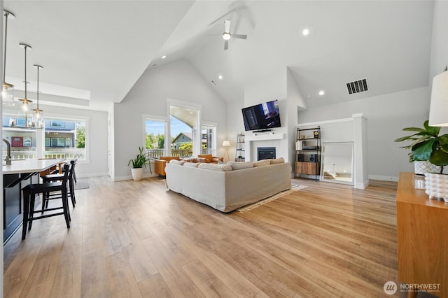 235 Champagne Way, Walla Walla, WA 99362 - living room with high vaulted ceiling, a ceiling fan, a fireplace, light wood-style floors, and recessed lighting