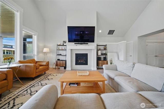 235 Champagne Way, Walla Walla, WA 99362 - living area with wood finished floors, high vaulted ceiling, a glass covered fireplace, and baseboards