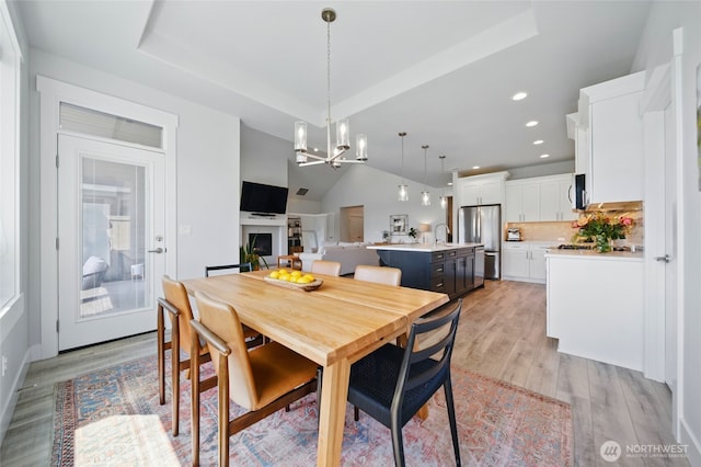 235 Champagne Way, Walla Walla, WA 99362 - dining area with light wood-style floors, a chandelier, recessed lighting, vaulted ceiling, and a tray ceiling