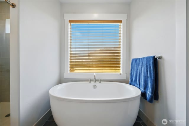 235 Champagne Way, Walla Walla, WA 99362 - bathroom featuring a freestanding bath, baseboards, and plenty of natural light