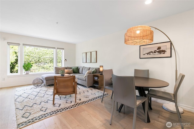 215 20th Ave E Unit 203, Seattle, WA 98112 - dining room featuring wood finished floors and baseboards