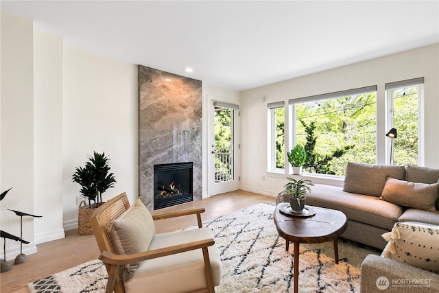 215 20th Ave E Unit 203, Seattle, WA 98112 - living area with baseboards, a high end fireplace, light wood-style flooring, and recessed lighting