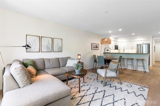 215 20th Ave E Unit 203, Seattle, WA 98112 - living area featuring light wood finished floors, recessed lighting, and baseboards