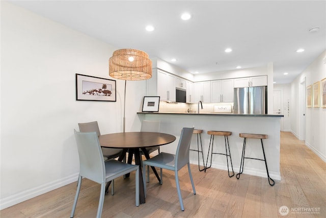 215 20th Ave E Unit 203, Seattle, WA 98112 - dining area with light wood-type flooring, baseboards, and recessed lighting