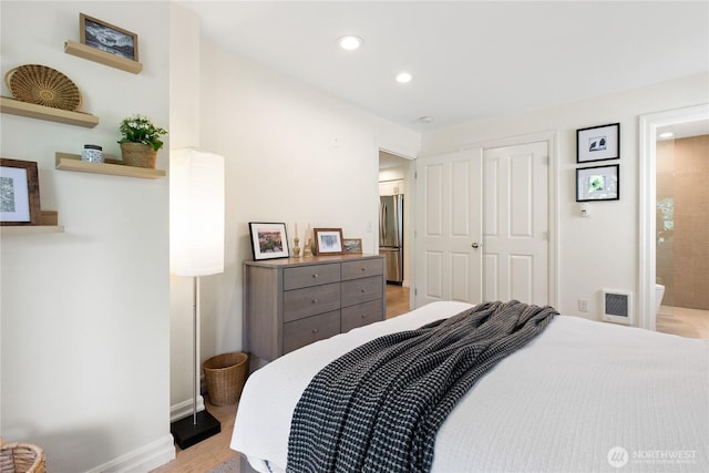 215 20th Ave E Unit 203, Seattle, WA 98112 - bedroom with freestanding refrigerator, light wood-type flooring, recessed lighting, baseboards, and a closet