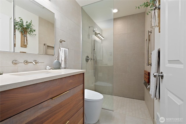 215 20th Ave E Unit 203, Seattle, WA 98112 - bathroom featuring vanity, walk in shower, toilet, tile walls, and tile patterned floors