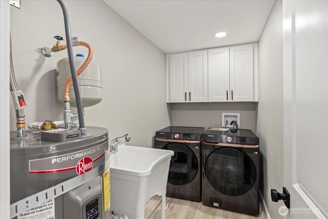 12102 19th Ct E, Edgewood, WA 98372 - washroom with water heater, washer and dryer, light wood finished floors, cabinet space, and recessed lighting