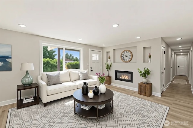 12102 19th Ct E, Edgewood, WA 98372 - living room featuring light wood-type flooring, recessed lighting, baseboards, and a glass covered fireplace