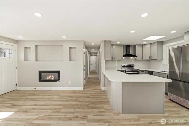 12102 19th Ct E, Edgewood, WA 98372 - kitchen with appliances with stainless steel finishes, wall chimney exhaust hood, gray cabinetry, light countertops, and recessed lighting