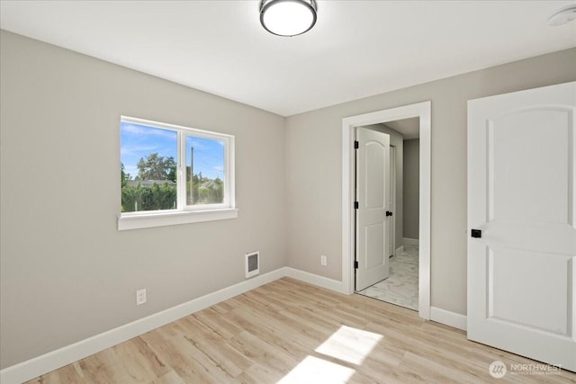 12102 19th Ct E, Edgewood, WA 98372 - unfurnished bedroom featuring baseboards and light wood-style flooring