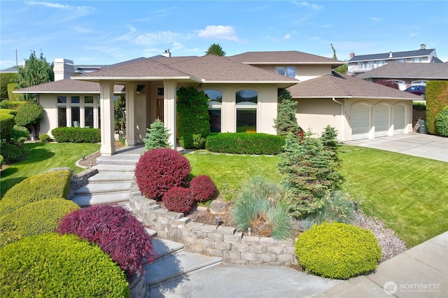 412 N 69th Ave, Yakima, WA 98908 - view of front facade with stucco siding, a garage, concrete driveway, and a front yard
