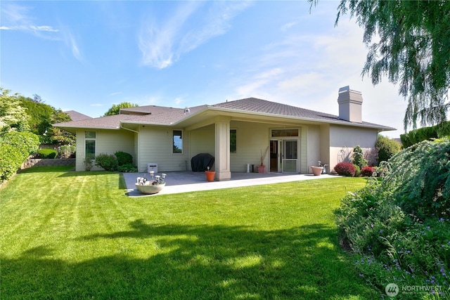 412 N 69th Ave, Yakima, WA 98908 - rear view of property with a patio area, a chimney, and a yard