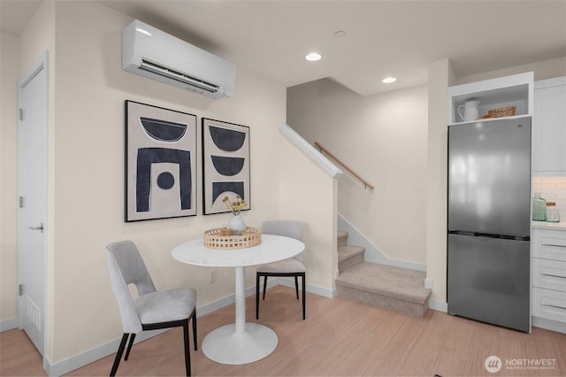 9217B Densmore Ave N, Seattle, WA 98103 - dining area featuring stairs, light wood-style floors, an AC wall unit, recessed lighting, and baseboards