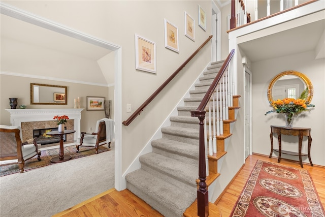 22233 NE 23rd St, Sammamish, WA 98074 - stairs featuring wood finished floors, a fireplace, and ornamental molding