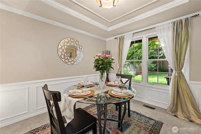 22233 NE 23rd St, Sammamish, WA 98074 - dining room with light colored carpet, a decorative wall, ornamental molding, and wainscoting