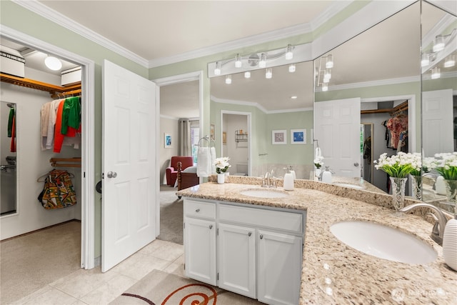 22233 NE 23rd St, Sammamish, WA 98074 - bathroom featuring double vanity, a walk in closet, tile patterned floors, and ornamental molding