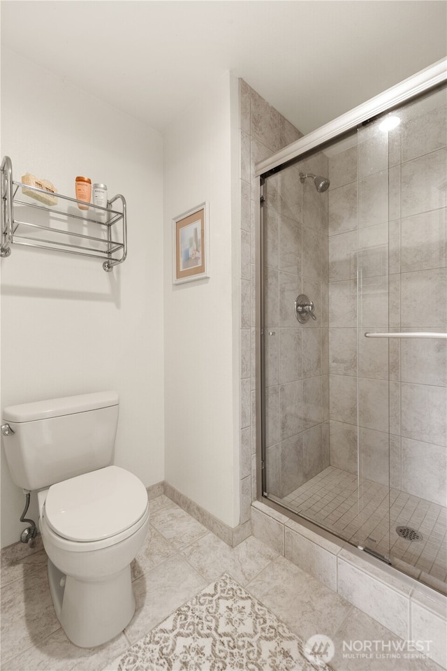 22233 NE 23rd St, Sammamish, WA 98074 - bathroom featuring toilet, a shower stall, tile patterned flooring, and baseboards
