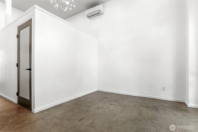 6704 15th Ave NW, Seattle, WA 98107 - interior space with a wall mounted AC, finished concrete flooring, a chandelier, and baseboards