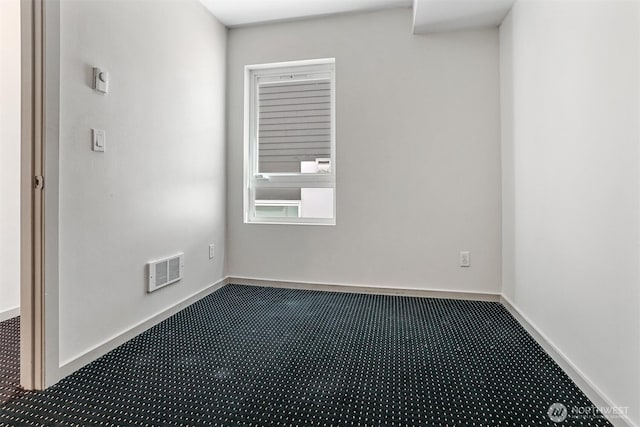 6704 15th Ave NW, Seattle, WA 98107 - unfurnished room with dark carpet and baseboards