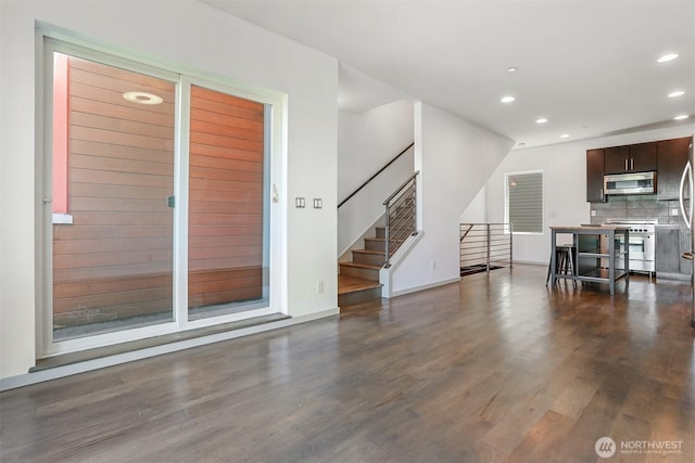 6704 15th Ave NW, Seattle, WA 98107 - kitchen with stainless steel appliances, recessed lighting, dark wood-style floors, tasteful backsplash, and dark brown cabinets