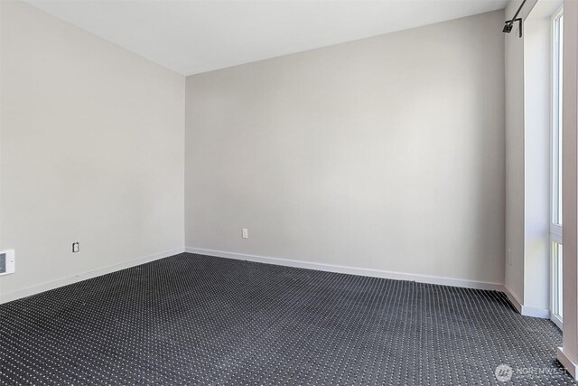 6704 15th Ave NW, Seattle, WA 98107 - empty room with dark colored carpet and baseboards