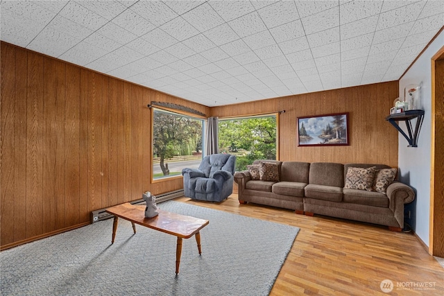 705 Old Kettle Rd, Kettle Falls, WA 99141 - living area with wood walls, wood finished floors, and baseboard heating