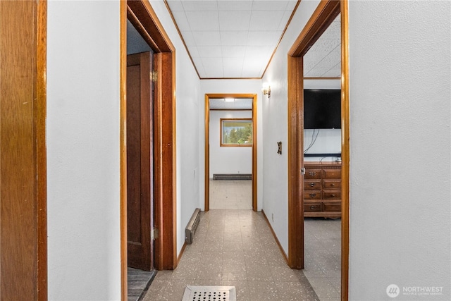 705 Old Kettle Rd, Kettle Falls, WA 99141 - hall featuring baseboards, a baseboard radiator, tile patterned floors, and crown molding