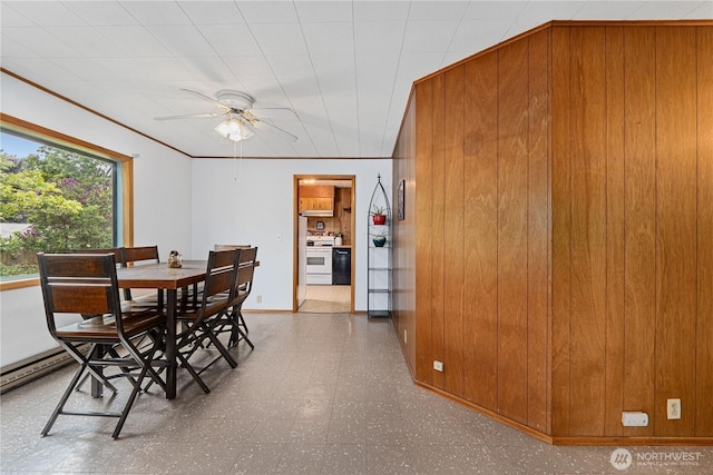 705 Old Kettle Rd, Kettle Falls, WA 99141 - dining room featuring tile patterned floors, ceiling fan, wood walls, and baseboards